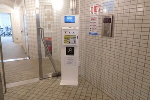 A public indoor space with a ticket vending machine, a digital information display, and a lift control panel. - City la Defense (Sapporo)