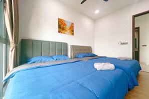 A hotel room with two beds, a green headboard, and a painting on the wall. - GYDEN STAYCATION #Green Haven near Senibong&Regency (Plentong)