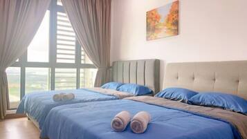 A hotel room with two beds, a large window with curtains, and a painting on the wall.