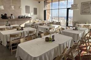 A restaurant with multiple tables, chairs, and a view of the outdoors. - Pana Unique Charyn (Enbekshikazakh District)