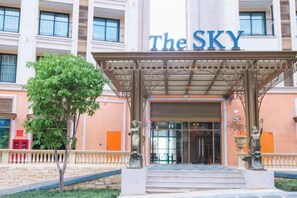 A hotel entrance with a covered entrance, steps leading up to it, and a large sign above the entrance. - Seaside Fireworks Apartment Free Pool & Gym (Phu Quoc Island)