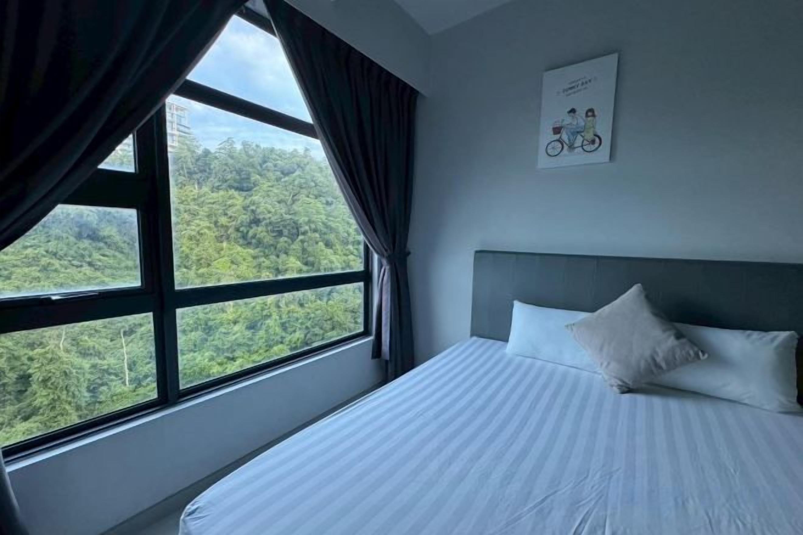 Ein Hotelzimmer mit großem Fenster, einem Bett und einem gerahmten Bild an der Wand.