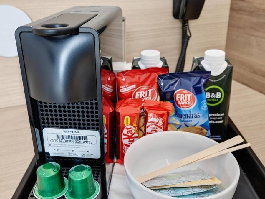 A coffee machine, snacks, a bowl with chopsticks, and a B&B juice carton.