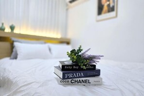 A neatly made bed with a stack of books and a small plant on top. - Near Hongik University/Subway Hapjeong Station 1 minute/8ppl/3br/4QBED/Near YG/iMac/Luggage storage (Seoul)