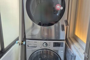 A compact washing machine and dryer unit with a control panel and a circular door. - Near Hongik University/Subway Hapjeong Station 1 minute/8ppl/3br/4QBED/Near YG/iMac/Luggage storage (Seoul)