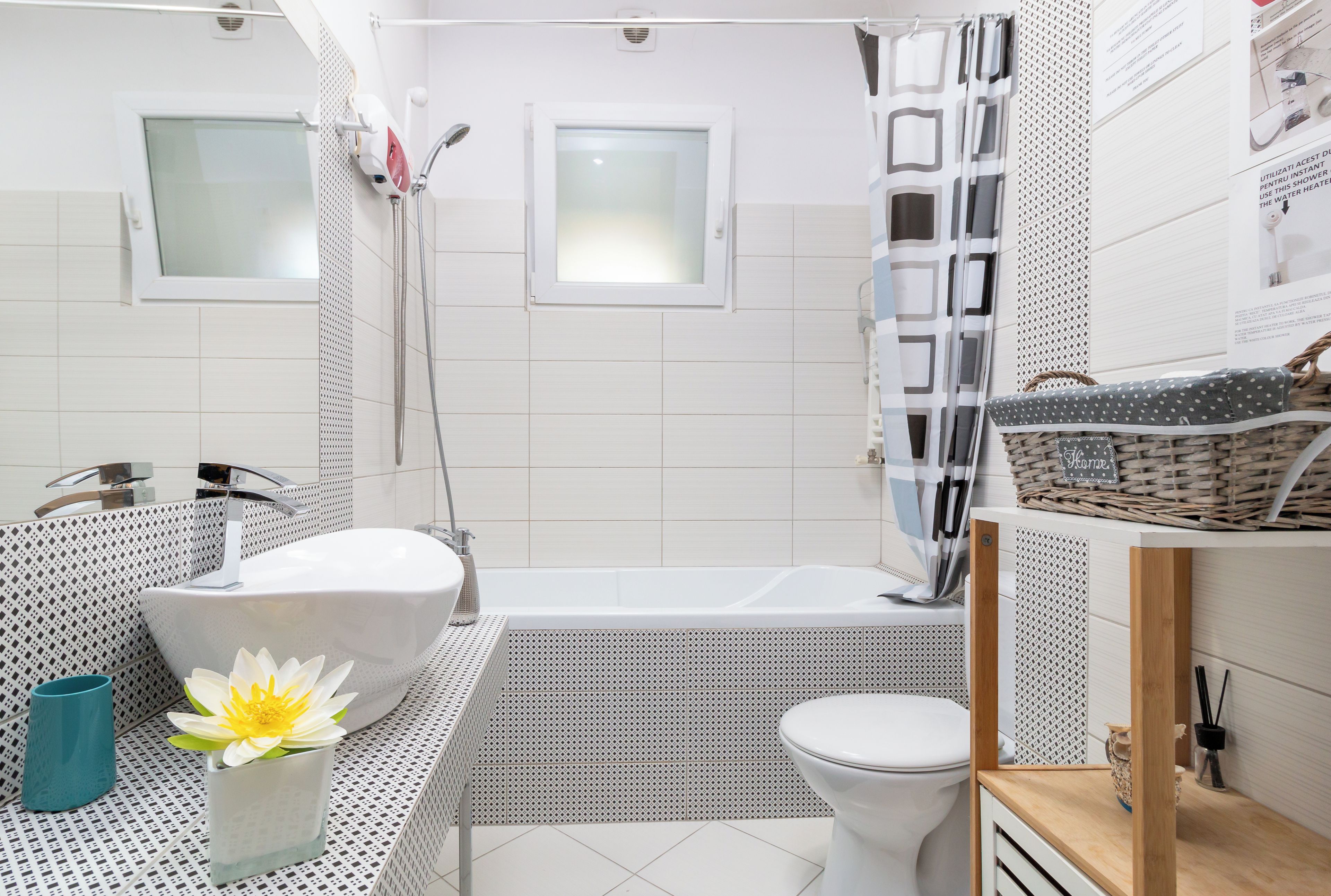 A modern bathroom with a freestanding bathtub, a toilet, and a shower area.