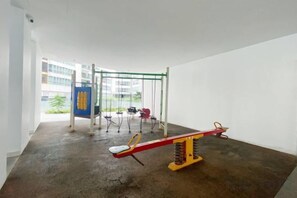 A playground with swings and a seesaw. - Homestay near to PWTC @ BY AWESOMESTAY (Kuala Lumpur)