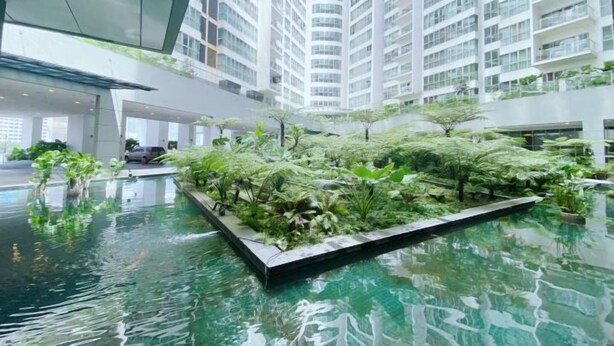 A modern building with a rooftop garden and a central water feature. - Homestay near to PWTC @ BY AWESOMESTAY (Kuala Lumpur)