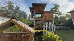 A wooden structure with a balcony and a sign that reads "SAILOM 1".