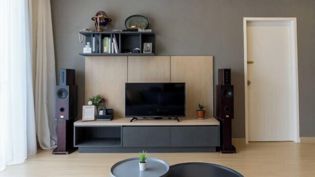 A modern living room with a flat-screen TV, a bookshelf, and a door. - Windmill Upon Hills By Rapi (Genting Highlands)