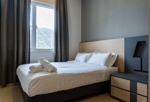 A modern hotel room with a large bed, a nightstand, and a window with curtains. - Windmill Upon Hills By Rapi (Genting Highlands)