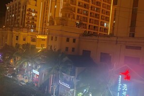 A multi-story building with balconies and a red star sign. - XINGHAI HOTEL AND RESORT (Boten)
