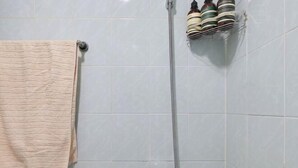 A bathroom with a towel rack, a shower head, and a soap dispenser. - Seoul Full House/Hongdae Entrance Sta.Exit 7. Party room. Big House. Two Rooms. (Seoul)