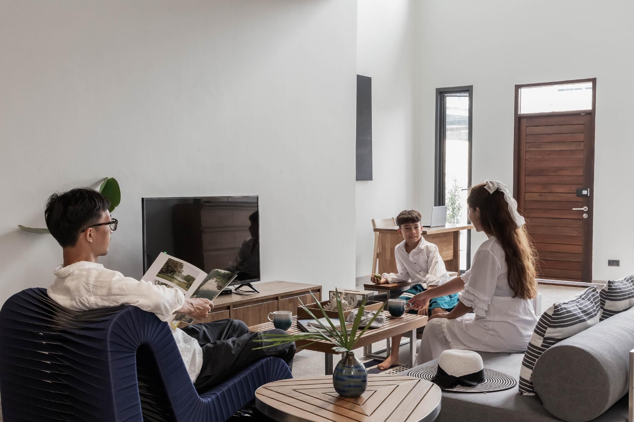 A modern living room with a sofa, a coffee table, and a television.