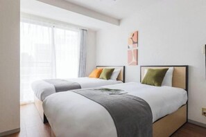 A hotel room with two beds, a large window with sheer curtains, and abstract wall art. - Cosmo Lead Minamiazabu (Tokyo)