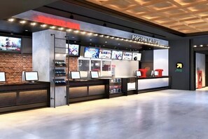 A modern food kiosk named 'Popcorn Factory' with multiple screens displaying menus. - PQG - Vinhomes Skylake - Lavish - Resplendent Apartments in Hanoi (Hanoi)