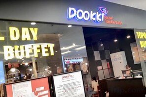 A Dookki Korean Topkaki Buffet sign, a Dookki menu board, and a Dookki promotional sign. - PQG - Vinhomes Skylake - Lavish - Resplendent Apartments in Hanoi (Hanoi)