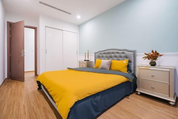 A bedroom with a bed, bedside table, and a wardrobe.
