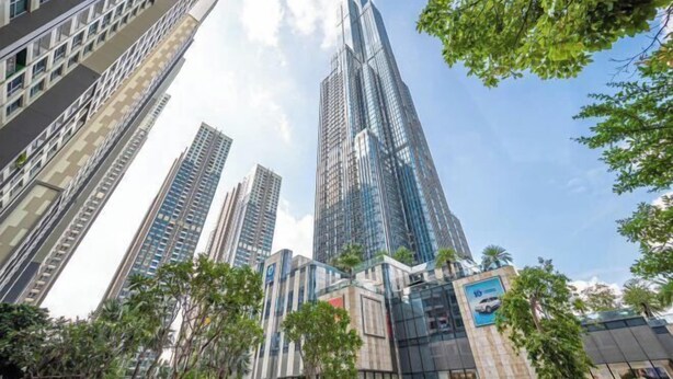 A modern high-rise building with a glass facade, surrounded by other tall buildings and greenery. - Condotel Imperial Landmark 81 (Ho Chi Minh City)