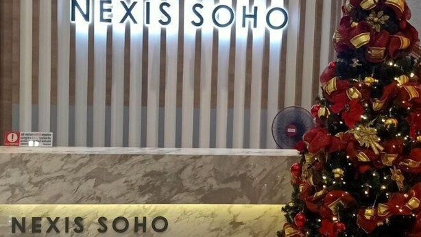 A reception area with a sign reading "NEXIS SOHO" and a decorated Christmas tree. - Sunway NEXIS, Kota Damansara (Petaling Jaya)