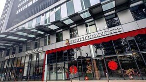 A modern building with a glass facade and signage for 'Fengyi Dumplings' and 'Insta Bean & Cream'. - Tropicana 218 With Sea View by LS Staycation (George Town)