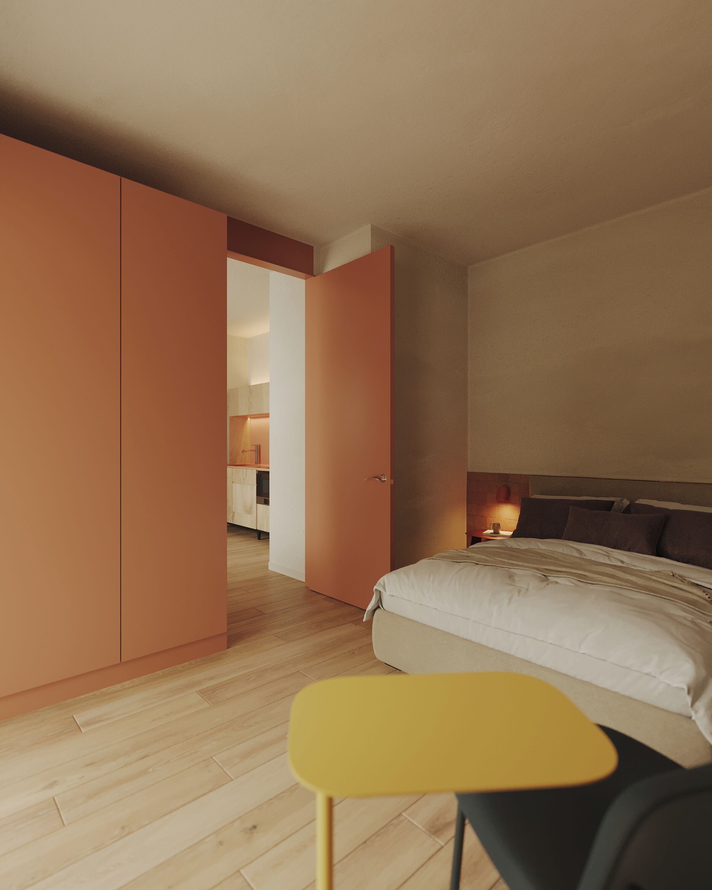 A bedroom with a bed, a nightstand, a yellow chair, and a wardrobe.