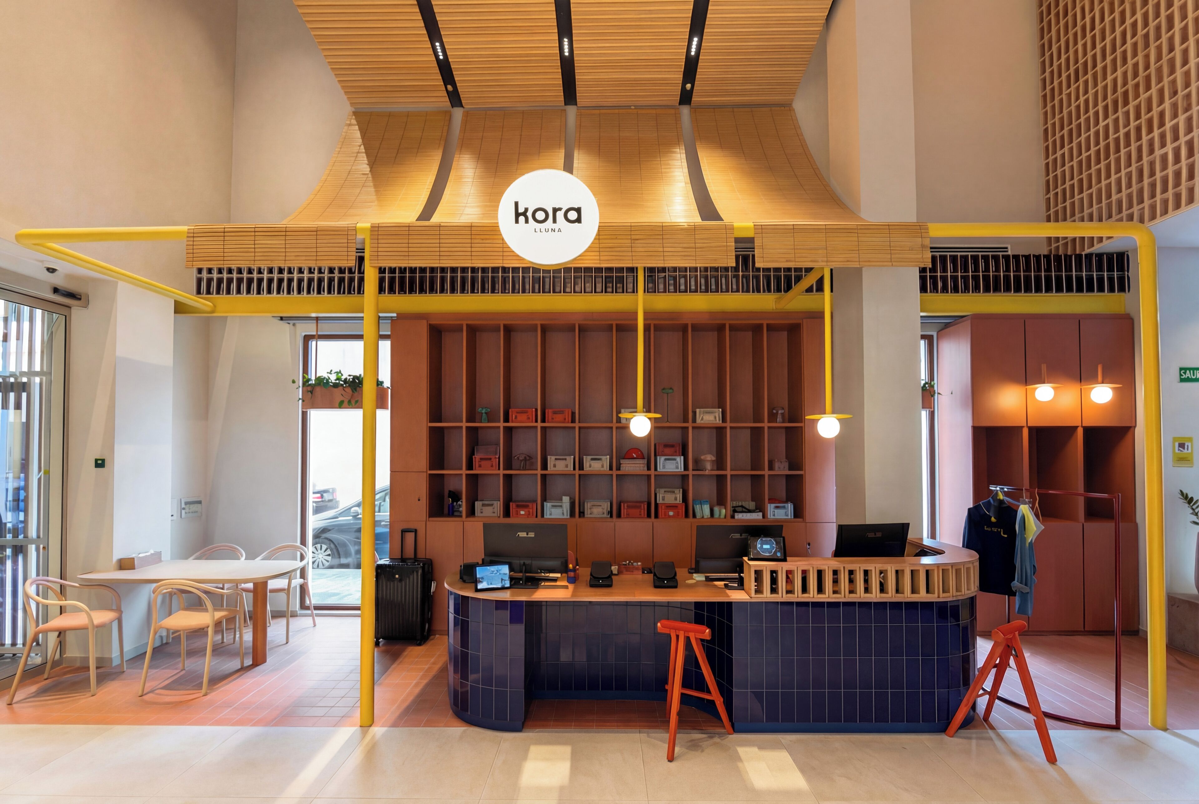 A modern interior with a central counter, seating area, and a visible logo.