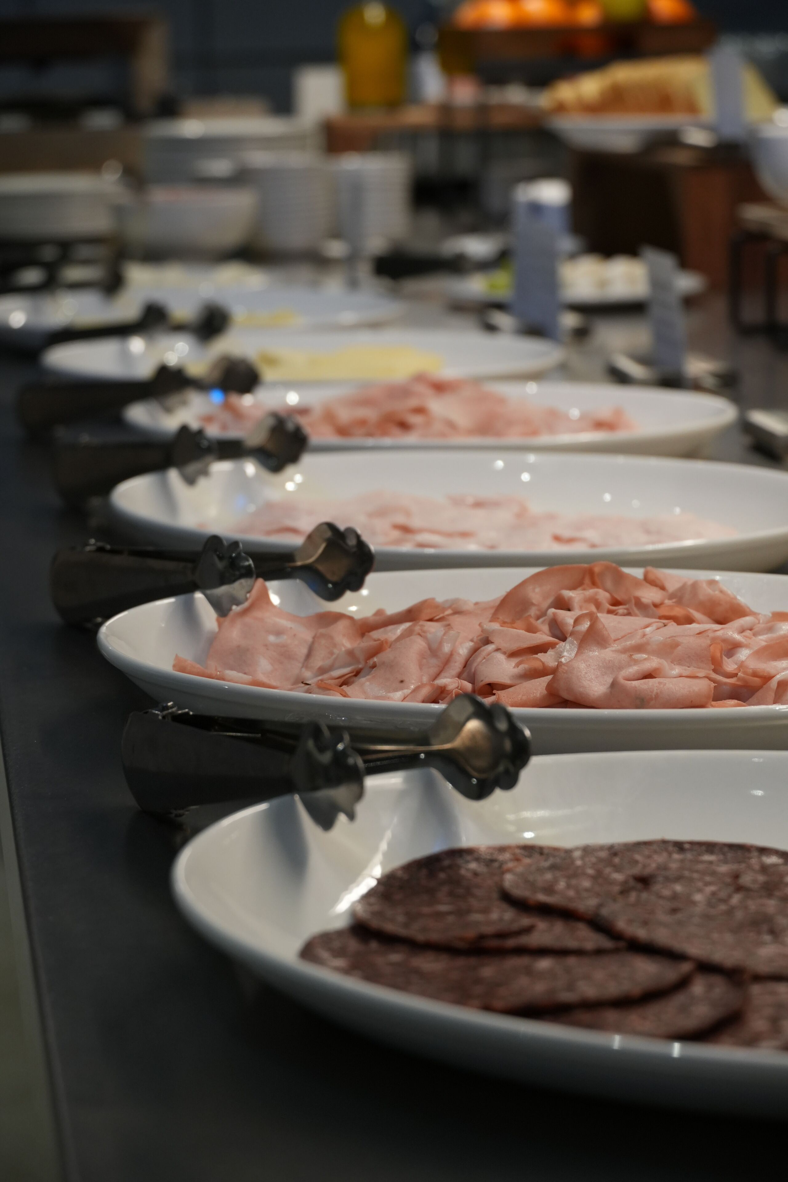 A buffet table with various food items.