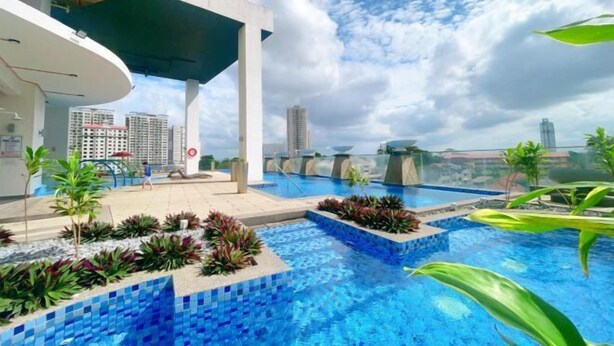 A rooftop pool with tiled blue water, surrounded by plants and modern architecture. - GYDEN STAYCATION #The Straits Johor Bahru (Johor Bahru)