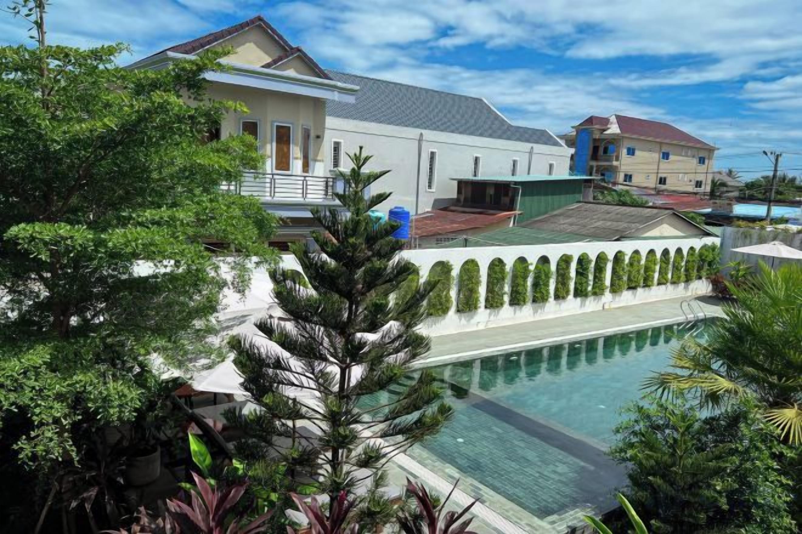 A pool area with a clear view of the surrounding buildings and greenery.