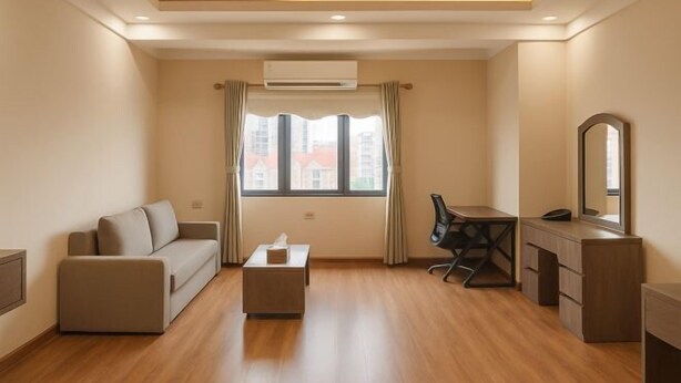 A modern room with a sofa, a desk, a chair, a small table, and a mirror. - XIAN HOTEL (The Grand Hotel) (Bac Ninh)