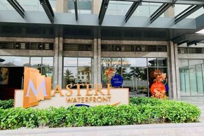 A hotel entrance with a sign reading "MASTER WATERFRONT" and a large 'M' logo. - Yangguang Elite - Vinhomes Ocean Park Ha Noi (Hanoi)
