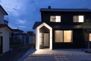 A modern two-story house with a garage and a small attached structure. - Biei Villa Gen (Kamikawa District)