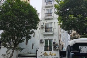 A multi-story building with balconies, air conditioning units, and a sign for 'Ar Spa'. - Ann Home (Ho Chi Minh City)