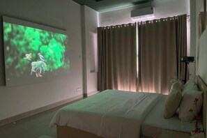 A bedroom with a bed, curtains, a projector screen, and a wall-mounted air conditioning unit. - Ann Home (Ho Chi Minh City)