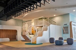 A modern interior with a staircase, seating areas, and a reception desk. - Societe Hartamas Kuala Lumpur (Kuala Lumpur)