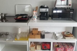 A kitchen area with a microwave, toaster, and a coffee maker on the countertop. - BUSAN YONGDO HAYANSUNG HOTEL (Busan)