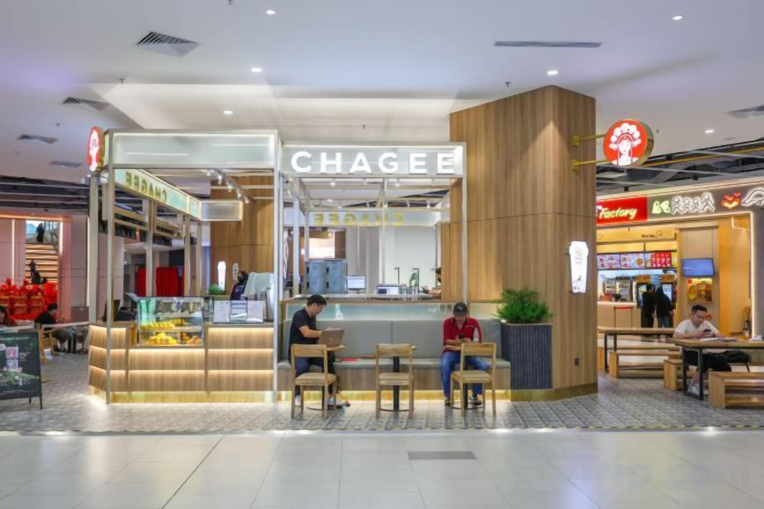 A food court with a Chapeau restaurant, seating areas, and a visible counter.