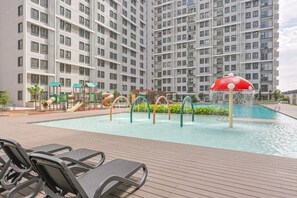 A swimming pool area with a water fountain, slides, and lounge chairs. - 168 Park Selayang by Fei Hong #Kuala Lumpur #Batu Caves #Kepong #New (Batu Caves)