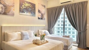 A hotel room with two beds, a large window with curtains, and artwork on the walls. - Silverscape Residence Sea View Melaka by Stayrene (Melaka)