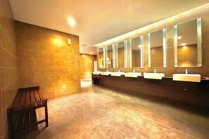 A public restroom with multiple sinks and mirrors.