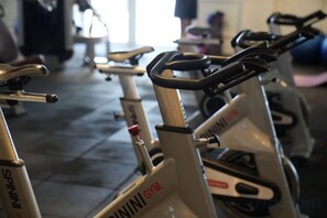 A row of stationary bikes in a gym with visible brand names and control panels. - Seven Seas Cote d'Azur One-bedroom near Beach (Pattaya)
