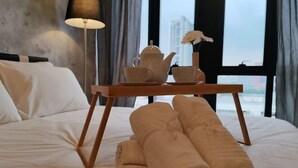 A neatly made bed with a tray of tea set and towels. - Pavillion Bukit Jalil 【Walk 5 mins】Stylish Studio 2-4 Pax (Kuala Lumpur)