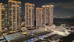 A high-rise residential building complex at night with illuminated windows and a well-lit parking area. - Pavillion Bukit Jalil 【Walk 5 mins】Stylish Studio 2-4 Pax (Kuala Lumpur)