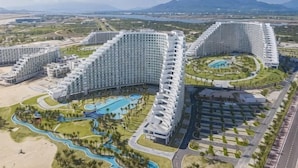 A resort with multiple high-rise buildings, a central pool, and surrounding greenery. - Sun SeaView Cam Ranh Resort (Cam Ranh)