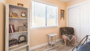 A room with a wooden bookshelf, a small table, a chair, and a bicycle. - Vineyard & Valley View Cottage w/hot tub
Tranquil Farmhouse w/stunning sunsets. (Templeton)