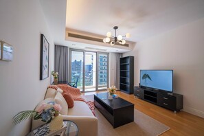 Superior Apartment, 1 Bedroom, Kitchen, City View | Living room | 55-inch Smart TV with cable channels