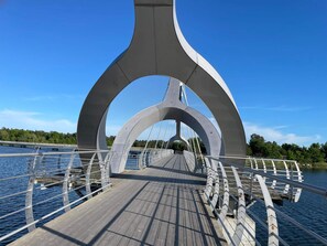 A pedestrian bridge with a wooden deck and metal railings. - 4 Star Holiday Home in Solvesborg (Sölvesborg)