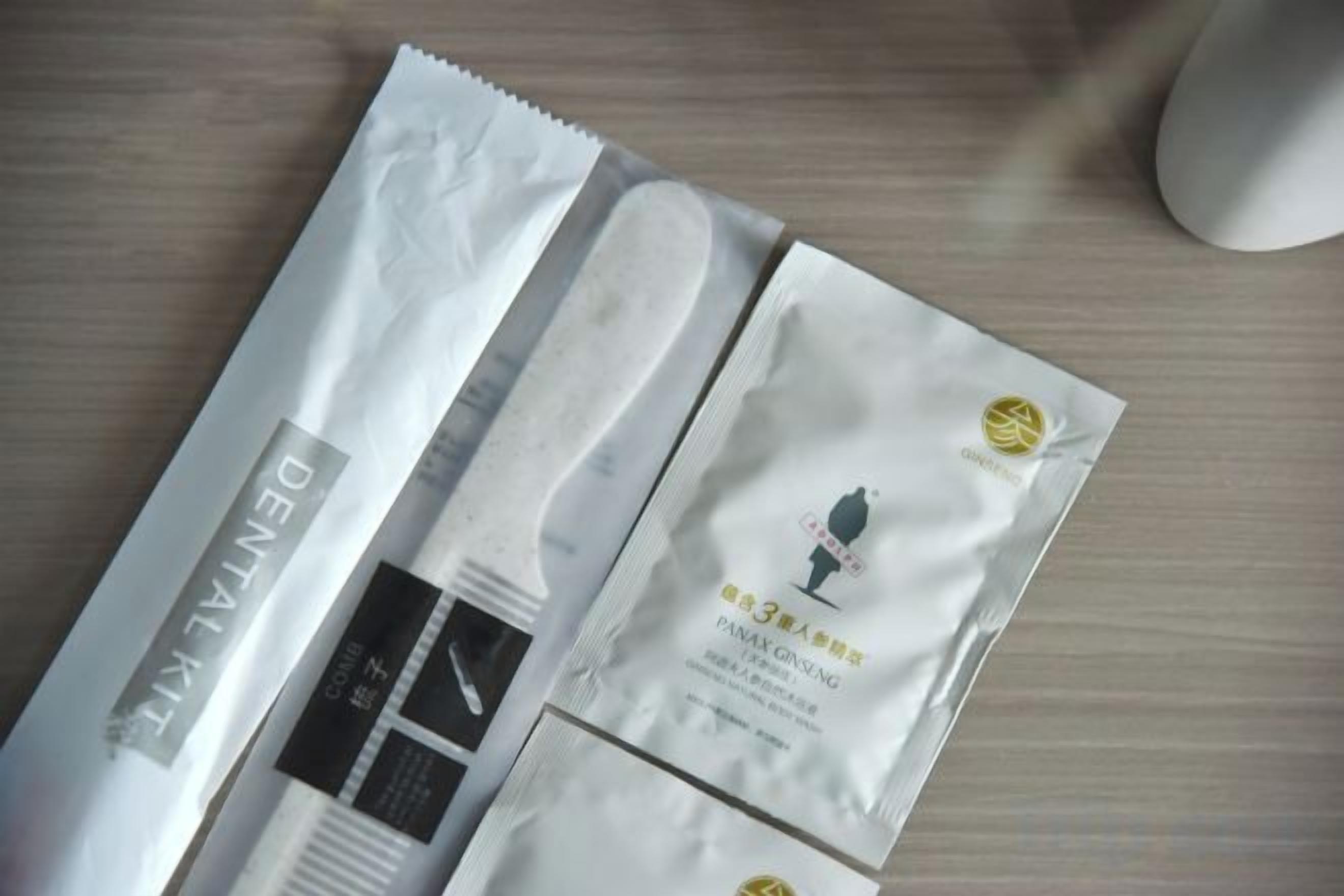 A package with a label that reads 'DENITAL KIT' and another with a logo and text that appears to be a product name.