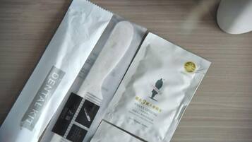 A package with a label that reads 'DENITAL KIT' and another with a logo and text that appears to be a product name.
